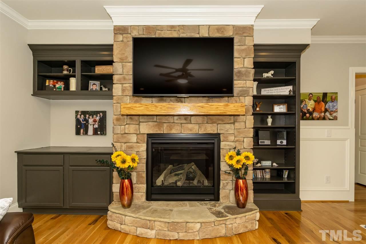 6112 Spring Branch Circle Raleigh, NC 27603 - Photo 12 of 30 a living room with fireplace and a flat screen tv