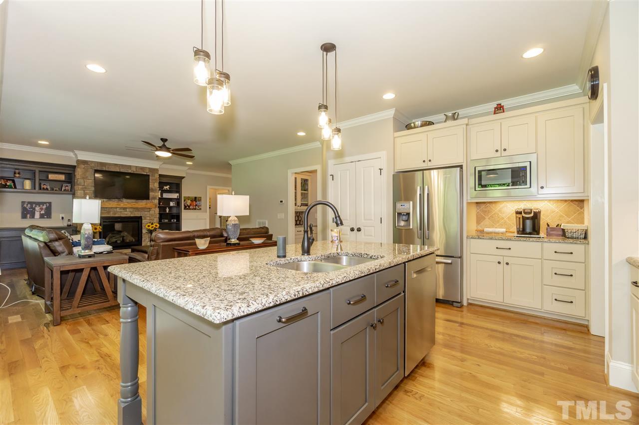 6112 Spring Branch Circle Raleigh, NC 27603 - Photo 14 of 30 a kitchen with stainless steel appliances granite countertop a sink refrigerator and cabinets