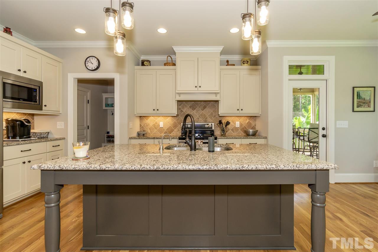 6112 Spring Branch Circle Raleigh, NC 27603 - Photo 15 of 30 a kitchen with stainless steel appliances granite countertop a sink refrigerator and cabinets