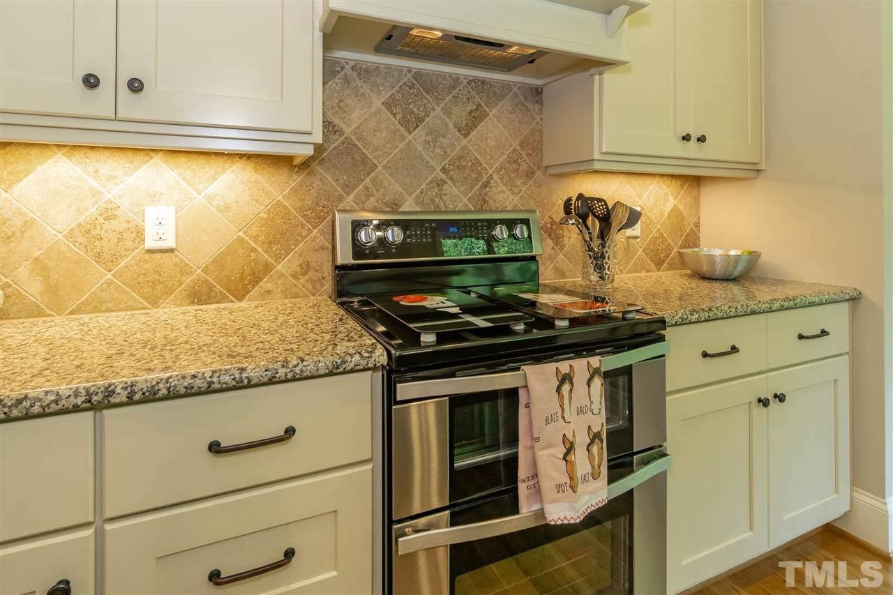 6112 Spring Branch Circle Raleigh, NC 27603 - Photo 17 of 30 a stove top oven sitting inside of a kitchen
