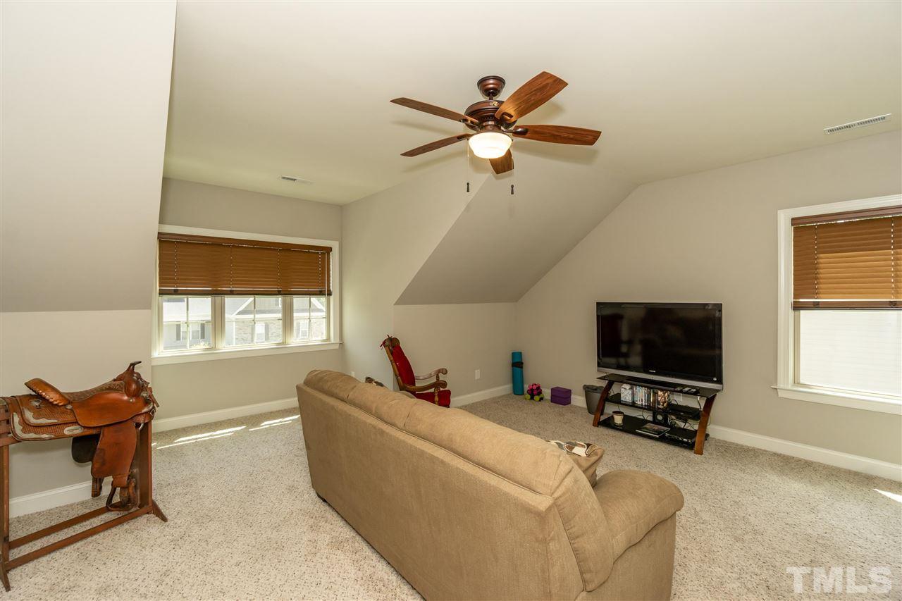 6112 Spring Branch Circle Raleigh, NC 27603 - Photo 20 of 30 a living room with furniture and a flat screen tv