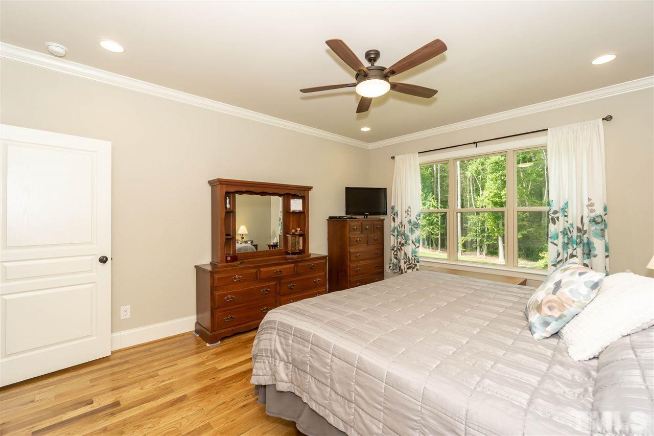 6112 Spring Branch Circle Raleigh, NC 27603 - Photo 21 of 30 a bedroom with a large bed and a large window