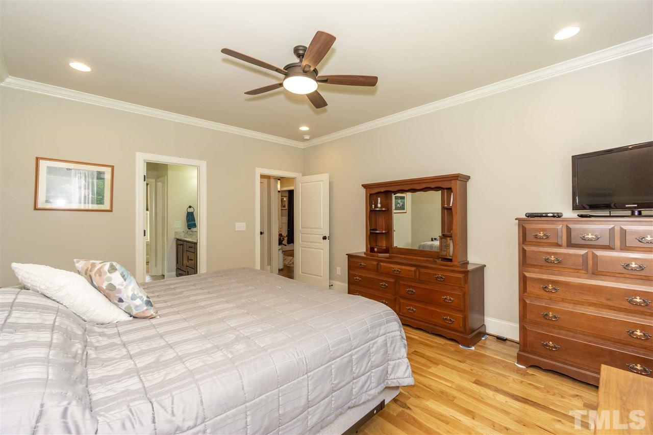 6112 Spring Branch Circle Raleigh, NC 27603 - Photo 23 of 30 a bedroom with a bed and a flat screen tv
