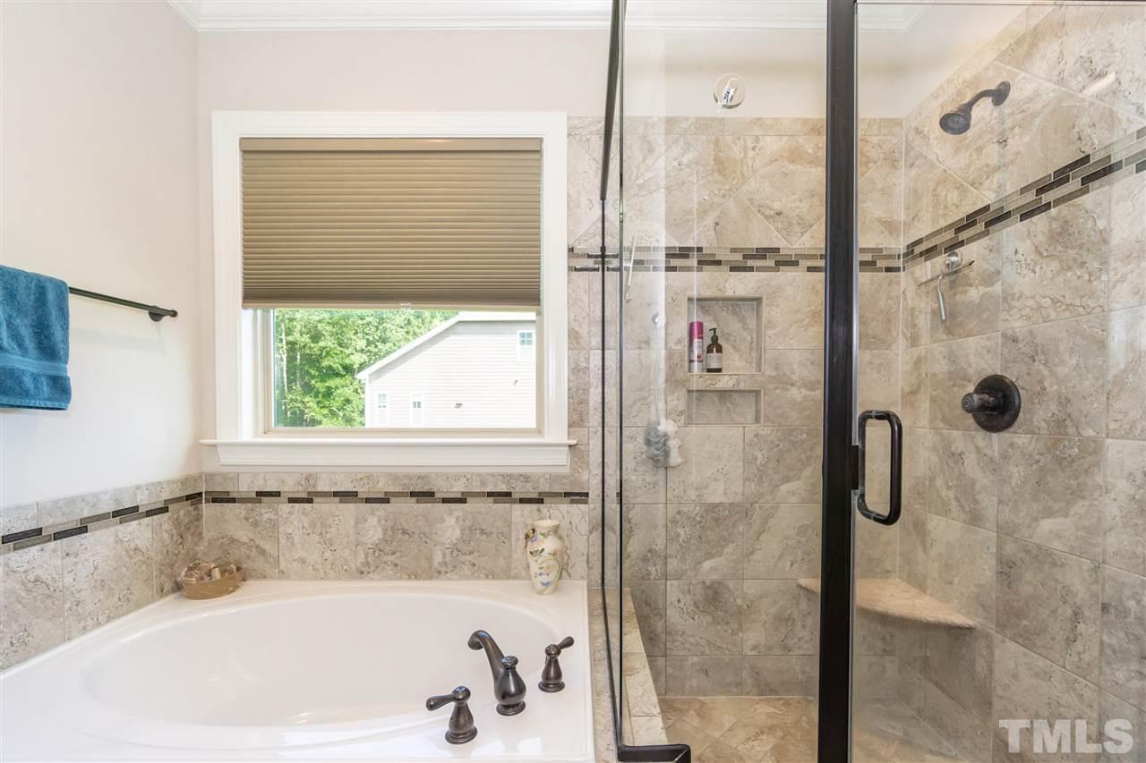 6112 Spring Branch Circle Raleigh, NC 27603 - Photo 25 of 30 a bath tub sitting next to a shower