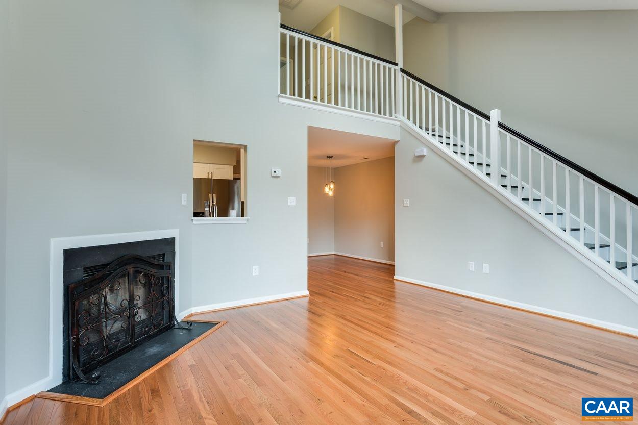 1006 Ridgeley Court Charlottesville, VA 22901 - Photo 13 of 25 a view of an empty room with wooden floor and a fireplace