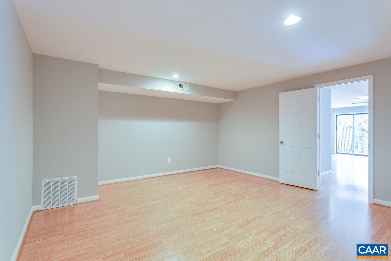 1006 Ridgeley Court Charlottesville, VA 22901 - Photo 18 of 25 a view of an empty room with wooden floor