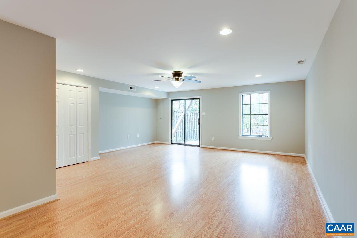 1006 Ridgeley Court Charlottesville, VA 22901 - Photo 20 of 25 a view of an empty room with wooden floor and a window