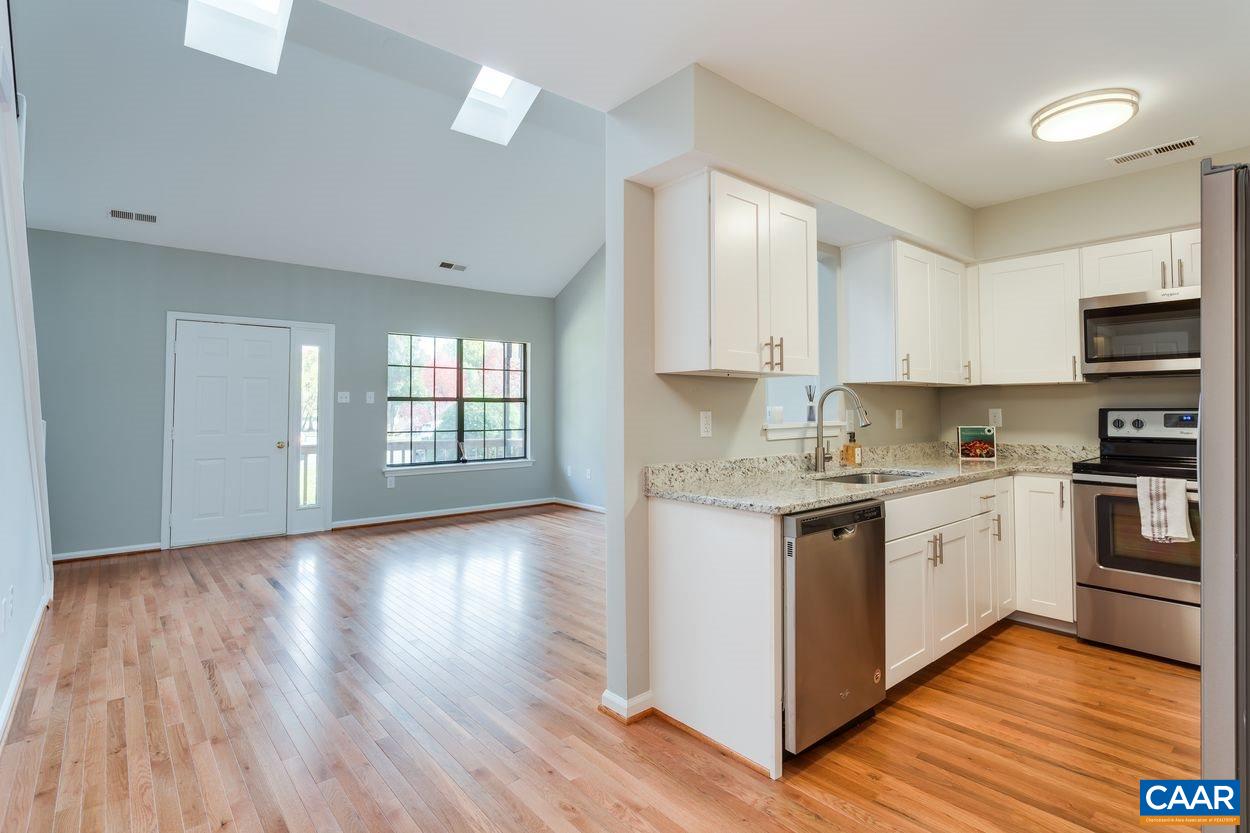 1006 Ridgeley Court Charlottesville, VA 22901 - Photo 4 of 25 a kitchen with granite countertop white cabinets and white appliances