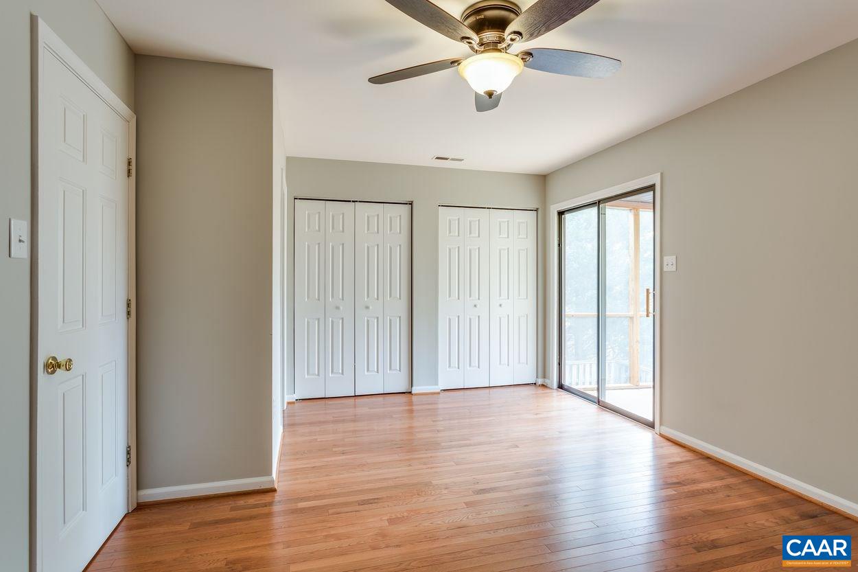 1006 Ridgeley Court Charlottesville, VA 22901 - Photo 8 of 25 an empty room with wooden floor fan and windows