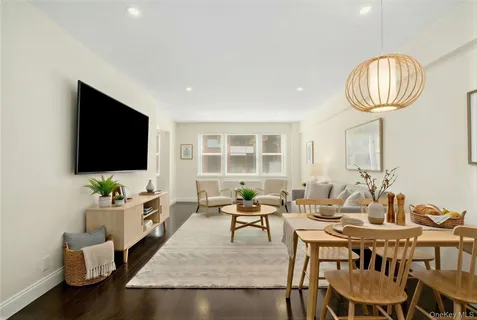 a living room with furniture a flat screen tv and a large window