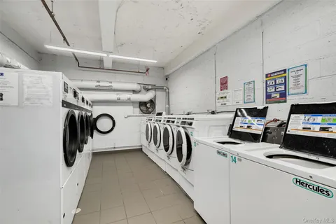 a utility room with multiple dryer and washer