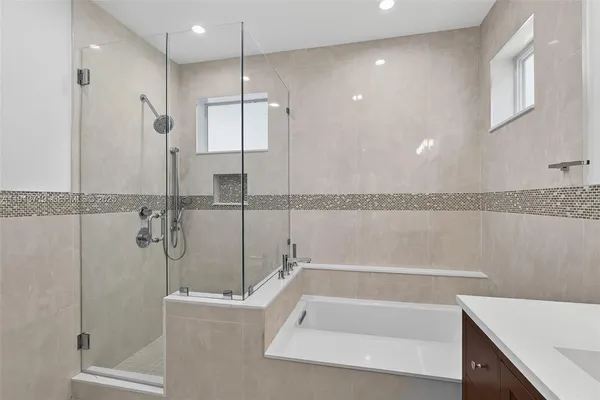 a bathroom with a bathtub and a shower
