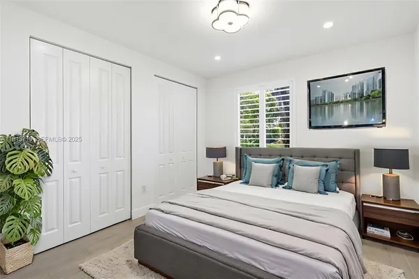 a bedroom with a bed and a painting on the wall