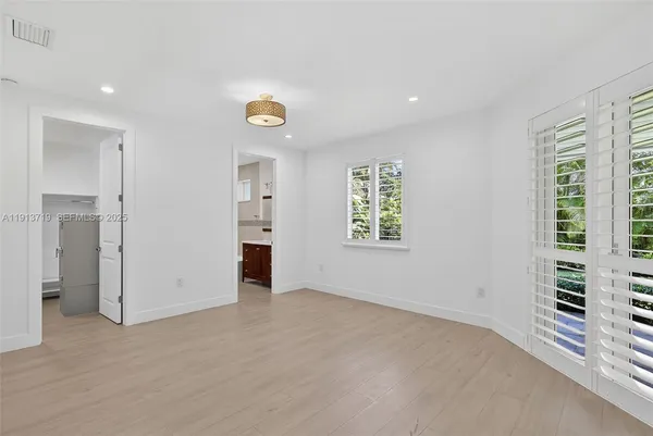 an empty room with windows and entrance