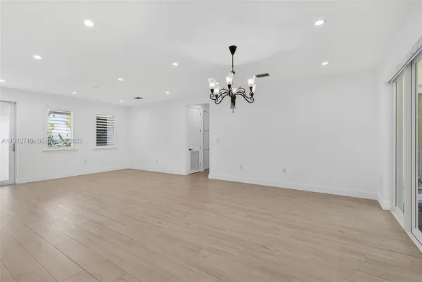 a view of an empty room with a chandelier