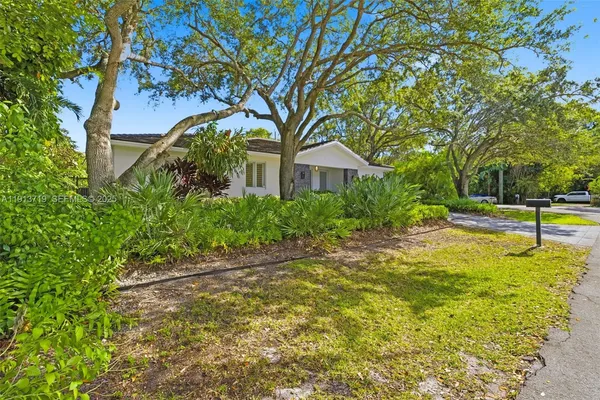 an aerial view of a house with a yard and garden
