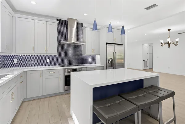a kitchen with a sink cabinets and wooden floor