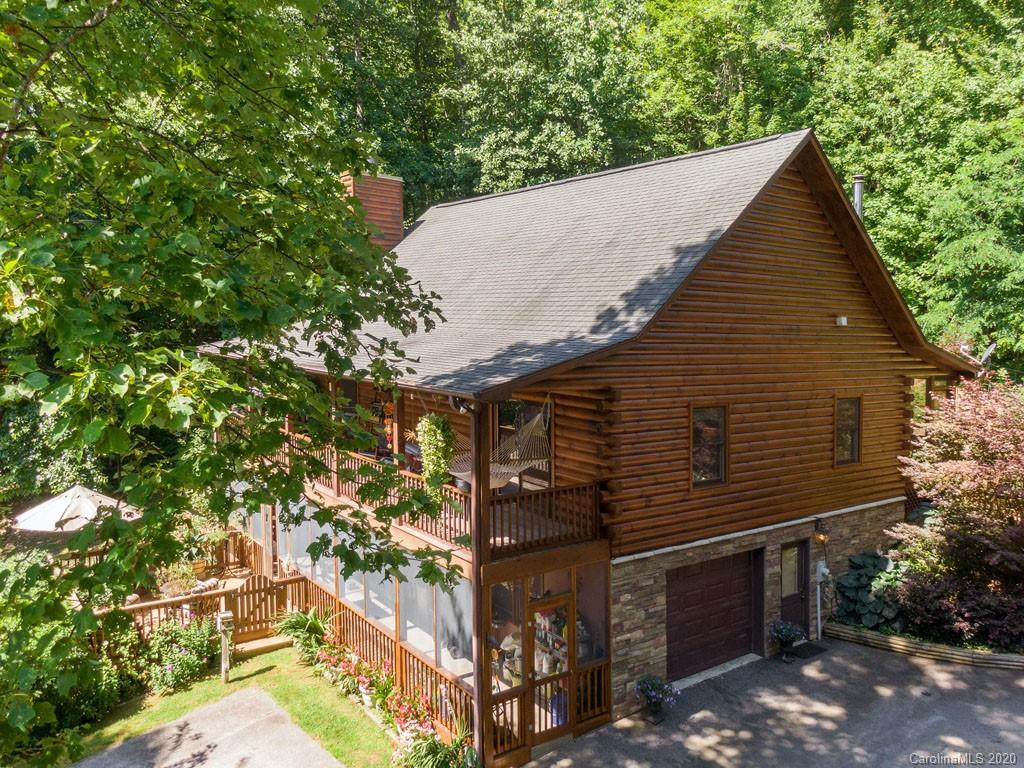 475 Indian Ridge Trail Hendersonville, NC 28739 - Photo 2 of 34 a backyard of a house with lots of green space