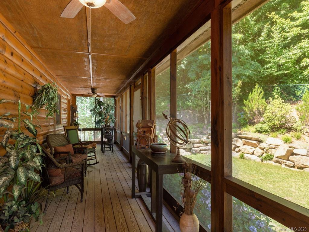 475 Indian Ridge Trail Hendersonville, NC 28739 - Photo 13 of 34 a view of a balcony with chairs and wooden floor