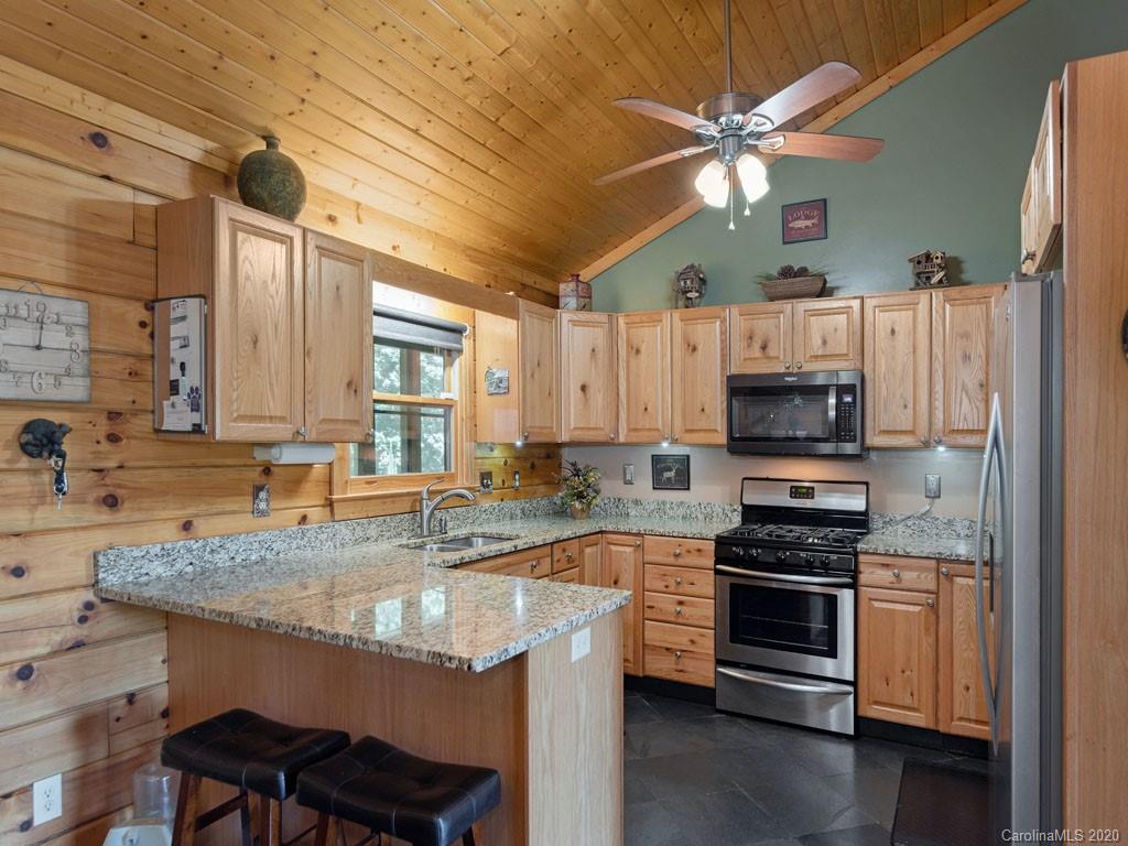 475 Indian Ridge Trail Hendersonville, NC 28739 - Photo 14 of 34 a kitchen with stainless steel appliances granite countertop a sink stove and refrigerator