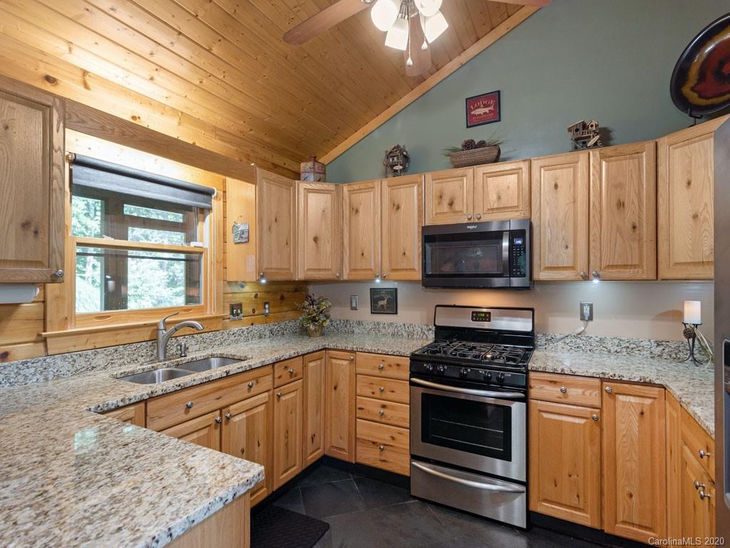 475 Indian Ridge Trail Hendersonville, NC 28739 - Photo 15 of 34 a kitchen with stainless steel appliances granite countertop a sink a stove and cabinets