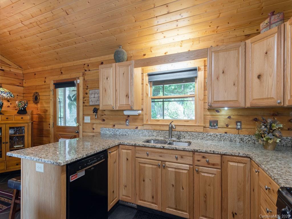 475 Indian Ridge Trail Hendersonville, NC 28739 - Photo 16 of 34 a kitchen with granite countertop cabinets sink and window