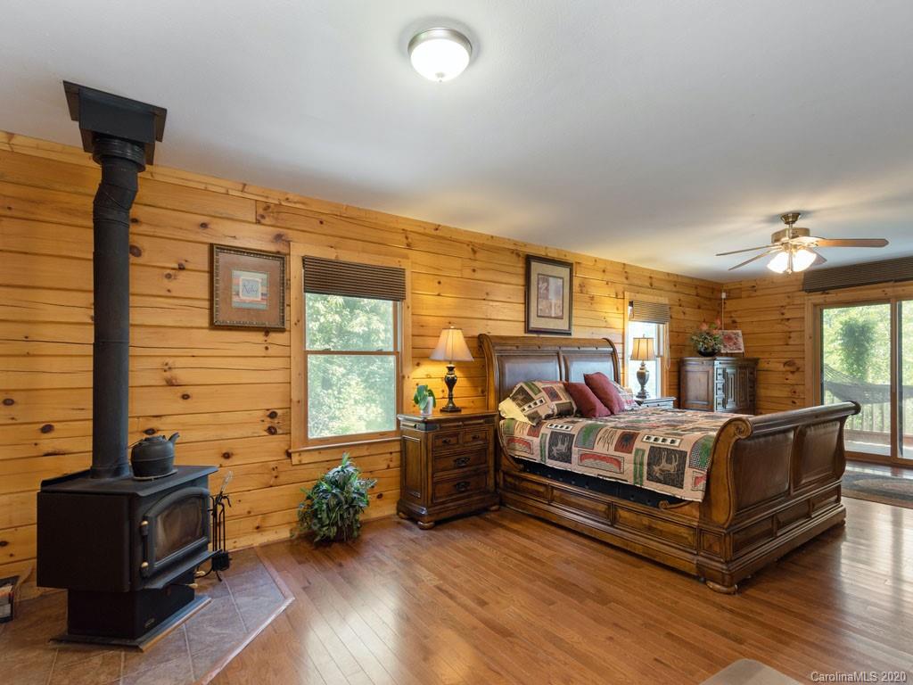 475 Indian Ridge Trail Hendersonville, NC 28739 - Photo 17 of 34 a bedroom with furniture and wooden floor