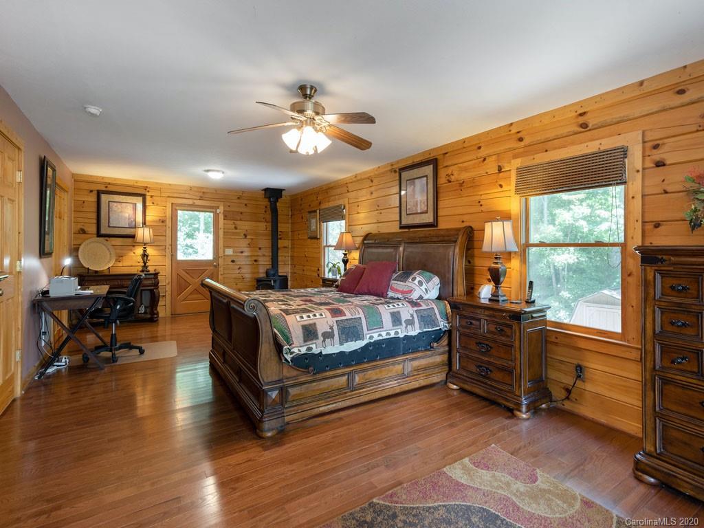 475 Indian Ridge Trail Hendersonville, NC 28739 - Photo 18 of 34 a bedroom with a bed and wooden floor
