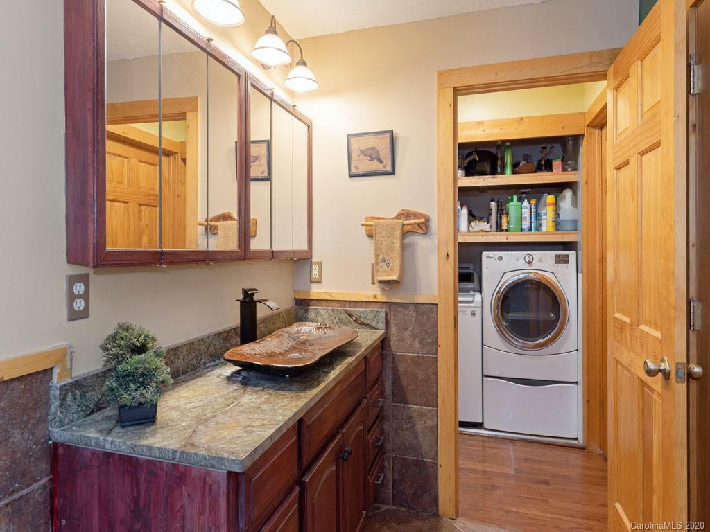 475 Indian Ridge Trail Hendersonville, NC 28739 - Photo 20 of 34 a kitchen with a granite countertop sink and cabinets