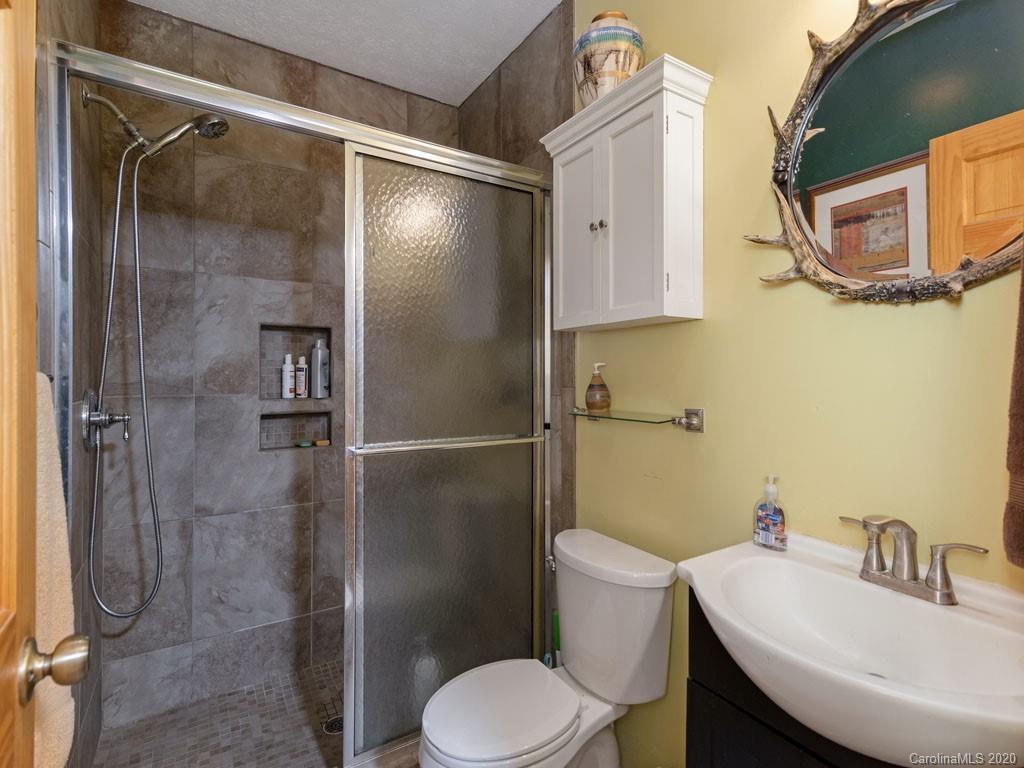 475 Indian Ridge Trail Hendersonville, NC 28739 - Photo 25 of 34 a bathroom with a sink toilet and shower