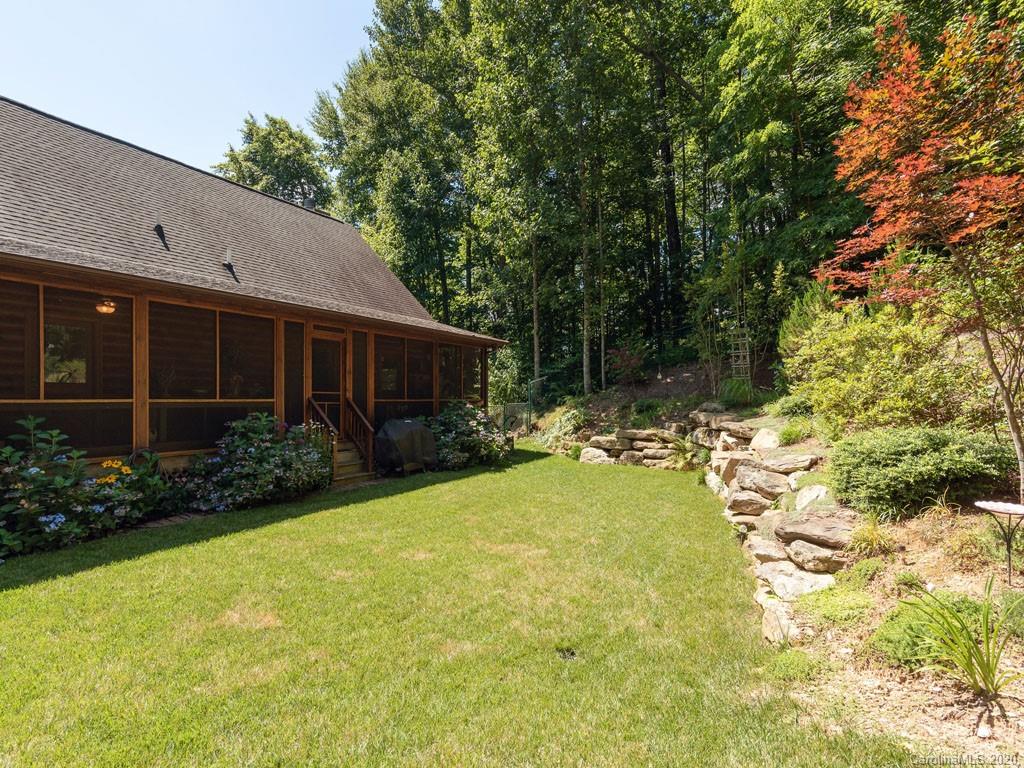 475 Indian Ridge Trail Hendersonville, NC 28739 - Photo 30 of 34 a view of a house with backyard and garden