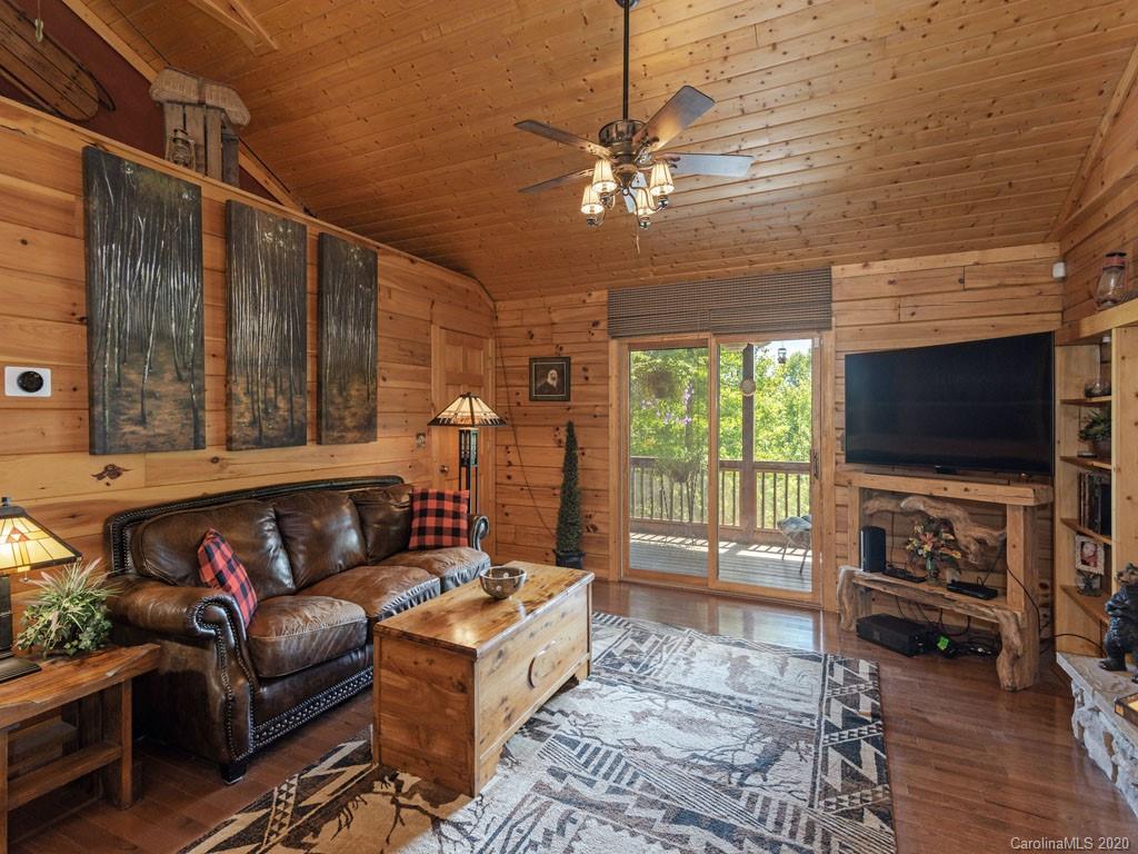 475 Indian Ridge Trail Hendersonville, NC 28739 - Photo 4 of 34 a living room with furniture and a flat screen tv