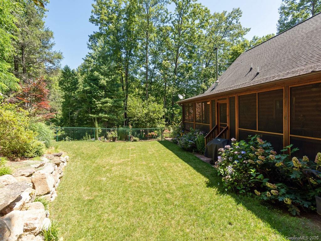 475 Indian Ridge Trail Hendersonville, NC 28739 - Photo 31 of 34 a view of a backyard with plants and large tree