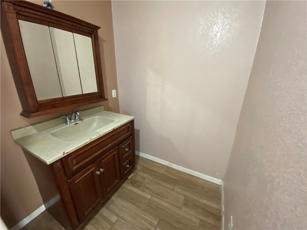 1211 Highland Avenue Alice, TX 78332 - Photo 14 of 28 a bathroom with a sink a vanity and a mirror