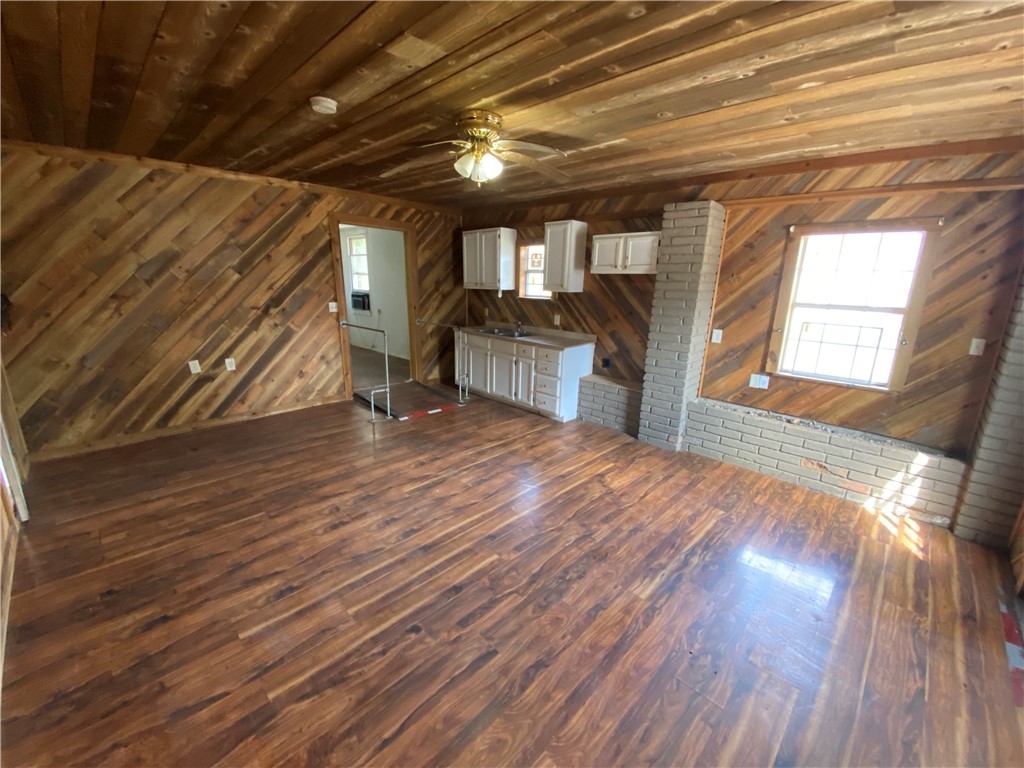 1211 Highland Avenue Alice, TX 78332 - Photo 21 of 28 a view of an empty room with wooden floor and a window