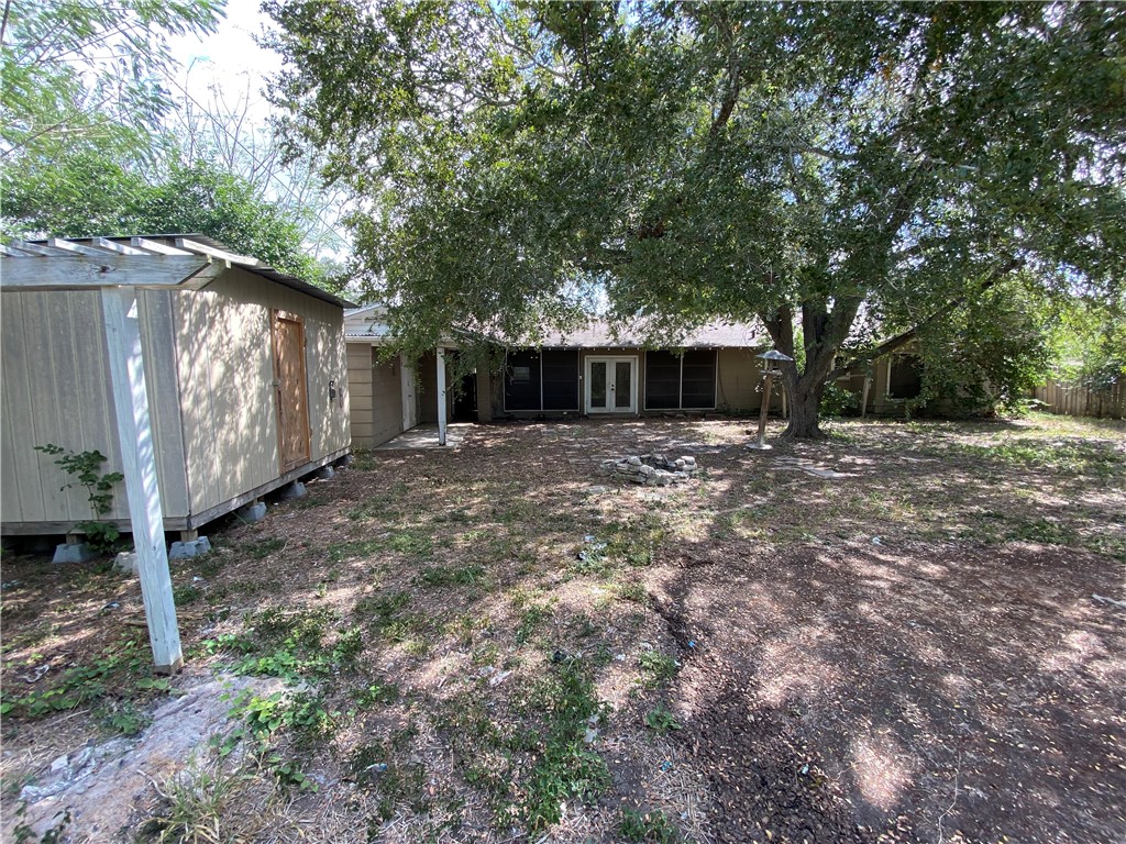 1211 Highland Avenue Alice, TX 78332 - Photo 27 of 28 a view of a house with a large tree and wooden fence