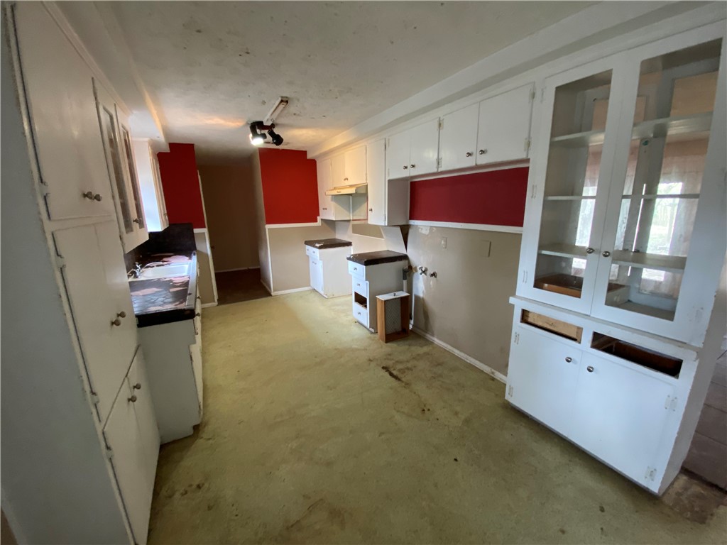1211 Highland Avenue Alice, TX 78332 - Photo 5 of 28 a kitchen with sink cabinets and stove