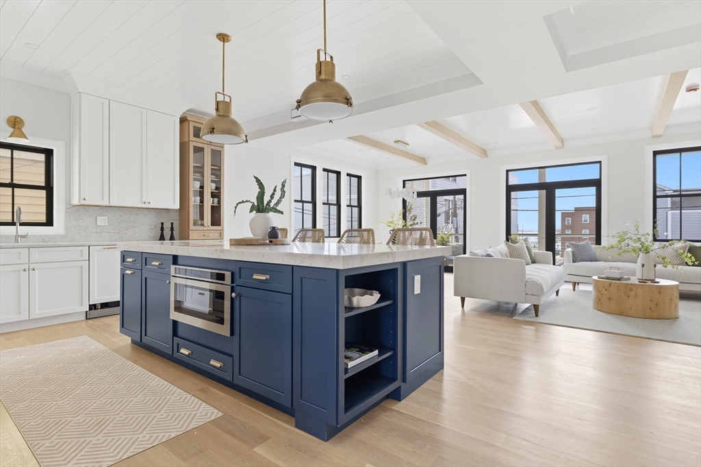 847 East 5th Street, Unit 2 Boston, MA 02127 - Photo 8 of 24 a kitchen with a stove a sink and a wooden floors