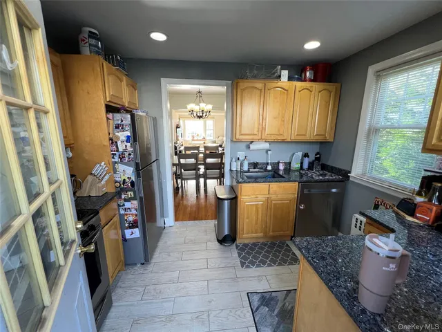 a kitchen with refrigerator and window