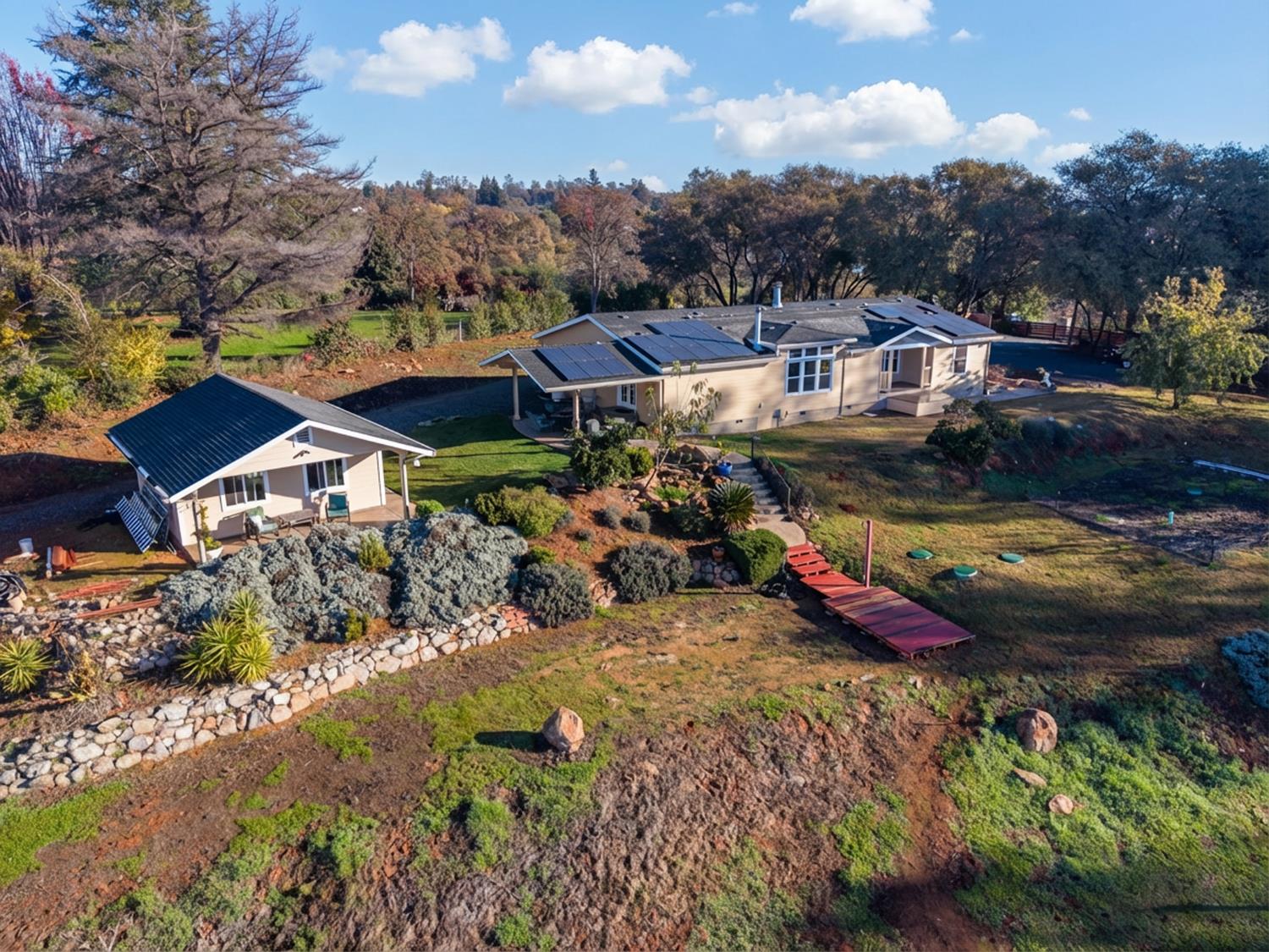 10665 Harris Road Auburn, CA 95603 - Photo 1 of 34 an aerial view of a house with swimming pool and mountains
