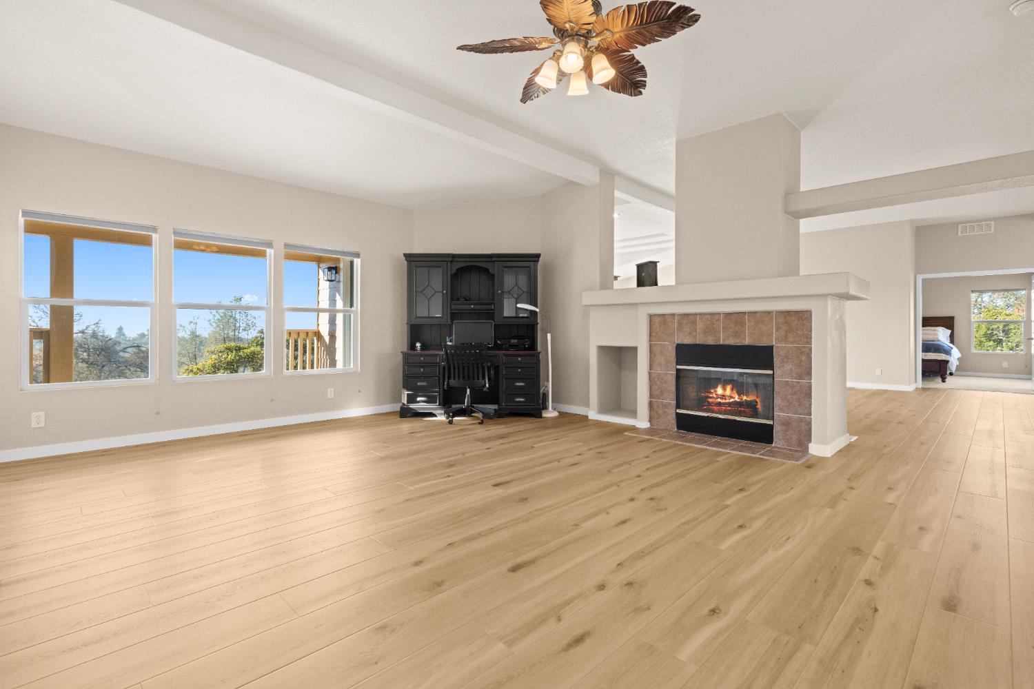 10665 Harris Road Auburn, CA 95603 - Photo 12 of 34 a view of an empty room with a fireplace and a window