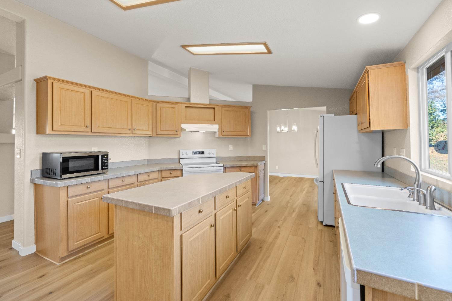 10665 Harris Road Auburn, CA 95603 - Photo 14 of 34 a kitchen with a sink a stove and cabinets