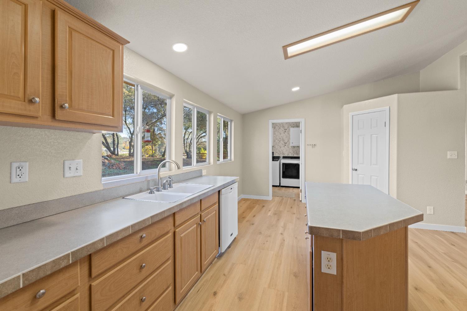 10665 Harris Road Auburn, CA 95603 - Photo 15 of 34 a large kitchen with kitchen island a sink stainless steel appliances and cabinets