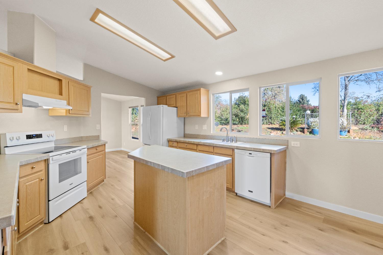 10665 Harris Road Auburn, CA 95603 - Photo 16 of 34 a kitchen with granite countertop a sink stove and cabinets