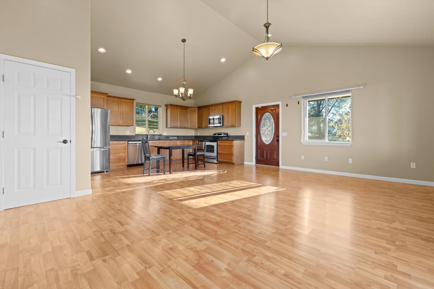 10665 Harris Road Auburn, CA 95603 - Photo 25 of 34 an open kitchen with wooden floor and chandelier