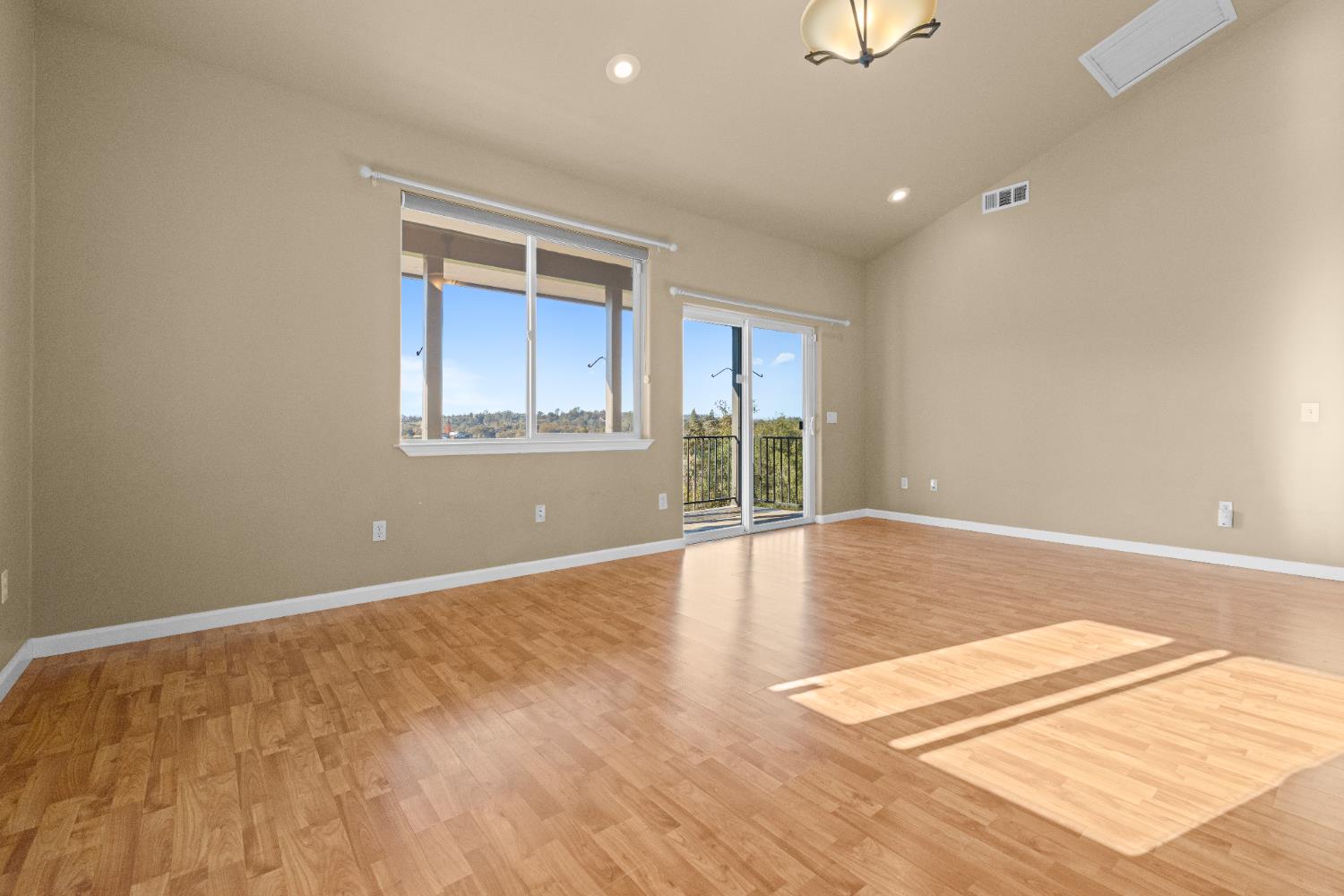 10665 Harris Road Auburn, CA 95603 - Photo 28 of 34 a view of an empty room with wooden floor and a window