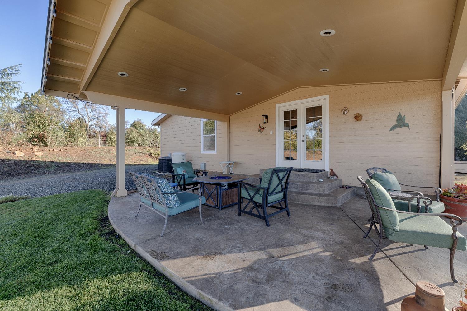 10665 Harris Road Auburn, CA 95603 - Photo 8 of 34 a view of a patio with table and chairs and potted plants