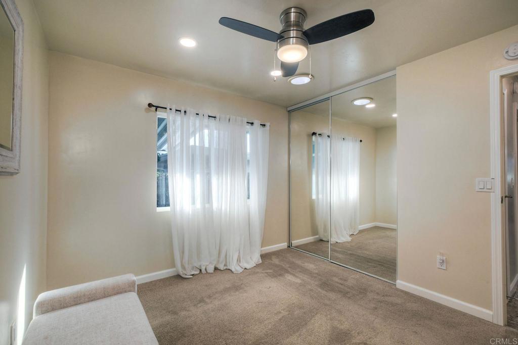 18218 Paradise Mountain Road Valley Center, CA 92082 - Photo 20 of 34 en view of a hallway with a chandelier fan and windows