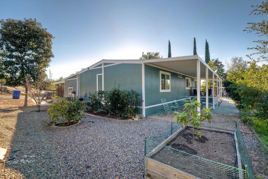 18218 Paradise Mountain Road Valley Center, CA 92082 - Photo 29 of 34 a front view of a house with garden