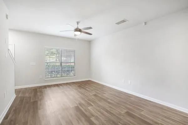 a kitchen with a refrigerator and white cabinets